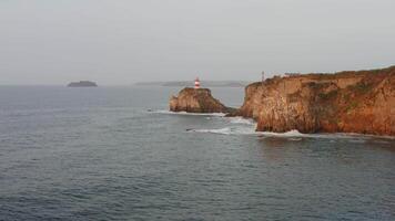Seaside beacon. Aerial view of the picturesque old lighthouse video