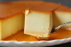 Caramel custard pudding on a plate on table photo