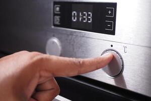 Adjusts temperature on oven for precise baking, providing culinary convenience for home chefs photo
