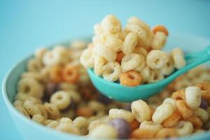 close up of colorful cereal corn flakes in a bowl photo