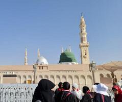 Medina, Saudi Arabia on March 2, 2024. Point of view of an Umrah or Hajj pilgrim walking in the courtyard of the Nabawi Mosque photo