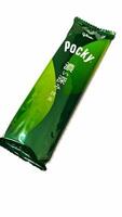 Osaka, Japan on October 1, 2023. A plastic pack of Matcha Flavored Pocky with Japanese writing on the packaging. photo