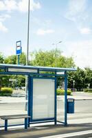 An empty stop with no people at all on a bright sunny day. photo