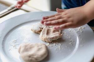 Child having fun modeling salt dough, authentic activity, fine motor skills development photo