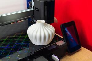 Four heads 3d printer, four extruders with an object on the tray, pla filament photo