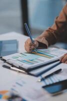 Business woman accountant working audit and calculating expense financial annual financial report balance sheet statement, doing finance making notes on paper checking document. photo