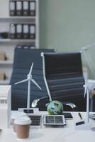 close up view of alternative energy engineer pointing to a solar power panel and discussion team for the future power in the studio photo
