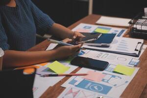 The designer team is designing the uxui system to make the uxui system work well on new phones and support system updates. Website development concept UI UX front end designer photo