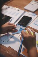 The designer team is designing the uxui system to make the uxui system work well on new phones and support system updates. Website development concept UI UX front end designer photo