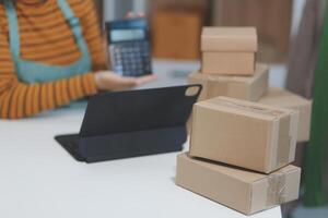 vlogger, blogger small SME business asian beautiful woman using mobile phone call for sell clothes live stream selling online, show product present detail at home office, entrepreneur ecommerce photo