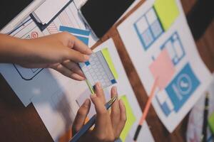 The designer team is designing the uxui system to make the uxui system work well on new phones and support system updates. Website development concept UI UX front end designer photo