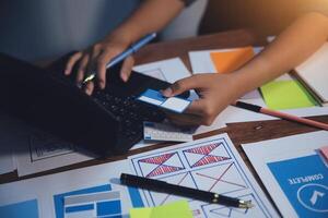 The designer team is designing the uxui system to make the uxui system work well on new phones and support system updates. Website development concept UI UX front end designer photo