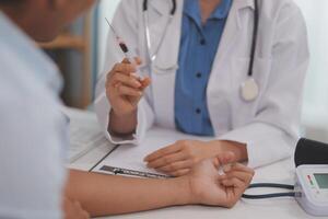 Doctor uses hypodermic needle and syringe to put a dose of medicine as treatment. photo