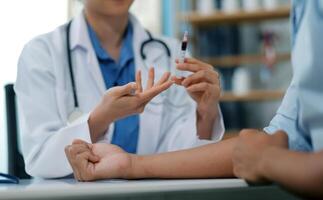 Doctor uses hypodermic needle and syringe to put a dose of medicine as treatment. photo