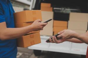Asian delivery express courier young man use giving boxes to woman customer he wearing protective face mask at front home photo