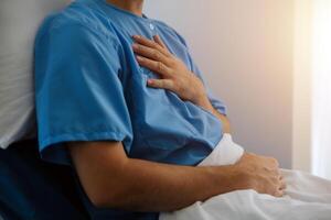 Male patient consulting a medical specialist at hospital. Chest pain and inflammatory heart disease photo