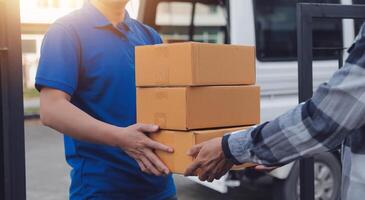 Asian delivery express courier young man use giving boxes to woman customer he wearing protective face mask at front home photo