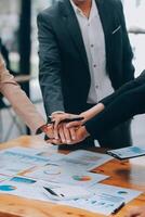 Motivated successful business team giving high five, happy young students employees group join hands with senior teacher mentor, team building unity concept, help support in teamwork, close up view photo