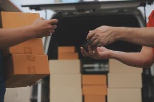 Asian delivery express courier young man use giving boxes to woman customer he wearing protective face mask at front home photo