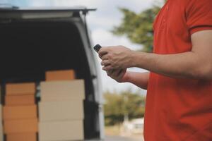 Asian delivery express courier young man use giving boxes to woman customer he wearing protective face mask at front home photo