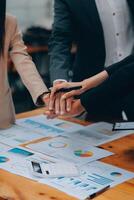 Motivated successful business team giving high five, happy young students employees group join hands with senior teacher mentor, team building unity concept, help support in teamwork, close up view photo