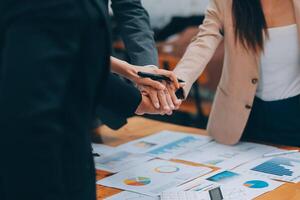 Motivated successful business team giving high five, happy young students employees group join hands with senior teacher mentor, team building unity concept, help support in teamwork, close up view photo