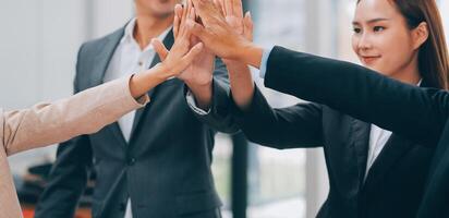 Motivated successful business team giving high five, happy young students employees group join hands with senior teacher mentor, team building unity concept, help support in teamwork, close up view photo