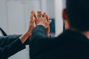Motivated successful business team giving high five, happy young students employees group join hands with senior teacher mentor, team building unity concept, help support in teamwork, close up view photo