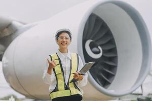 Technician fixing the engine of the airplane,Female aerospace engineering checking aircraft engines,Asian mechanic maintenance inspects plane engine photo