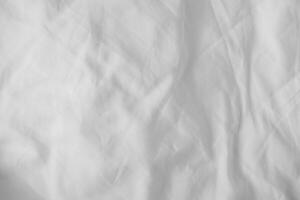 Abstract White Bedding Sheets or White wrinkled fabric background texture and Texture with copy space Creased or wrinkled white fabric,Soft focus photo