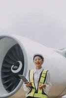 Technician fixing the engine of the airplane,Female aerospace engineering checking aircraft engines,Asian mechanic maintenance inspects plane engine photo