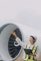 Technician fixing the engine of the airplane,Female aerospace engineering checking aircraft engines,Asian mechanic maintenance inspects plane engine photo