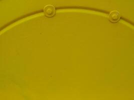 Yellow painted steel texture for a close-up background of a building or construction. photo