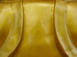Golden texture at Buddhist temple, close-up for abstract background. photo
