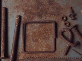 Rusted steel surface with old nails and equipment for a vintage background. photo