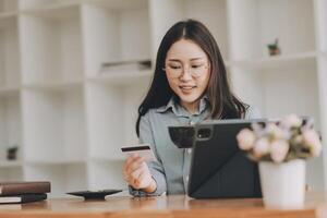 Happy asian woman using smartphone shopping online with credit card. Lifestyle. Easy pay using smart phone or digital device. photo