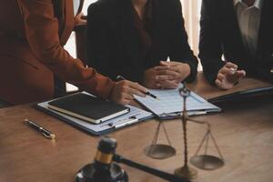 Lawyer, legal advisor, businessman brainstorming information on agreement details Business contracts in legal processing books for accuracy in contract documents. joint financial investment. photo