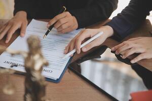 Lawyer, legal advisor, businessman brainstorming information on agreement details Business contracts in legal processing books for accuracy in contract documents. joint financial investment. photo