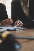 Lawyer, legal advisor, businessman brainstorming information on agreement details Business contracts in legal processing books for accuracy in contract documents. joint financial investment. photo