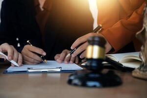Lawyer, legal advisor, businessman brainstorming information on agreement details Business contracts in legal processing books for accuracy in contract documents. joint financial investment. photo