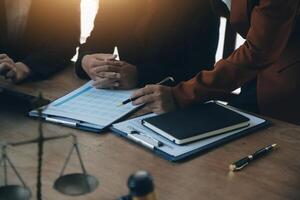 Lawyer, legal advisor, businessman brainstorming information on agreement details Business contracts in legal processing books for accuracy in contract documents. joint financial investment. photo