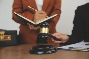 Lawyer, legal advisor, businessman brainstorming information on agreement details Business contracts in legal processing books for accuracy in contract documents. joint financial investment. photo