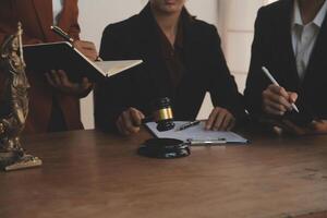 Lawyer, legal advisor, businessman brainstorming information on agreement details Business contracts in legal processing books for accuracy in contract documents. joint financial investment. photo