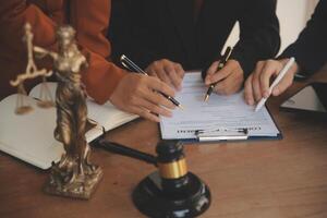 Lawyer, legal advisor, businessman brainstorming information on agreement details Business contracts in legal processing books for accuracy in contract documents. joint financial investment. photo
