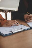 Lawyer, legal advisor, businessman brainstorming information on agreement details Business contracts in legal processing books for accuracy in contract documents. joint financial investment. photo