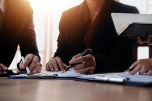 Lawyer, legal advisor, businessman brainstorming information on agreement details Business contracts in legal processing books for accuracy in contract documents. joint financial investment. photo