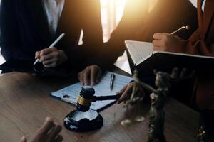 Lawyer, legal advisor, businessman brainstorming information on agreement details Business contracts in legal processing books for accuracy in contract documents. joint financial investment. photo