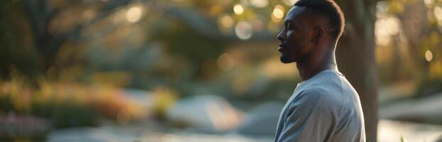 African Man Practicing Mindfulness Meditation in Peaceful Garden photo
