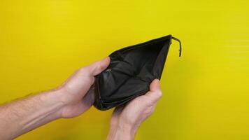 A worker looks into his empty wallet. Hands open a billfold, financial difficulties concept video