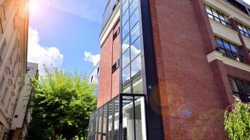 Brick and glass building. Glass architecture in office building. Reflection in windows. photo